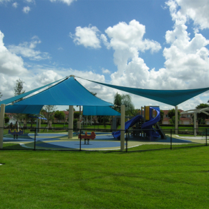 Image of playground equipment with shade structures and safety surfacing