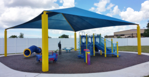 Image of completed playground installation with PIP safety surfacing and shelter shade